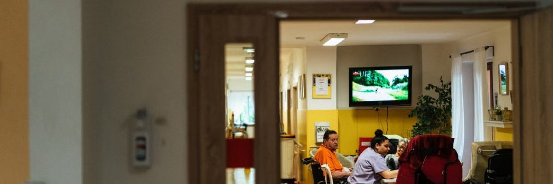 Healthcare professionals caring for elderly patients in a hospital setting, emphasizing support and care.